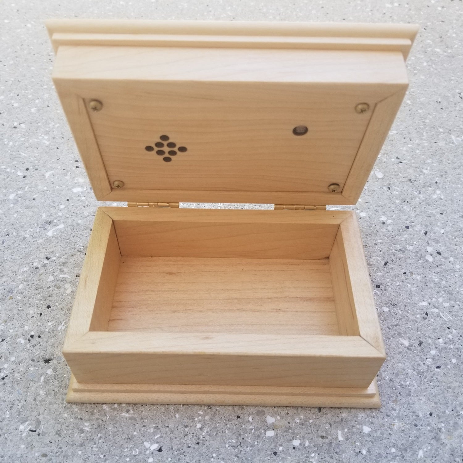 wooden music box with an open lid showing panel with the light sensor and the speaker under the lid