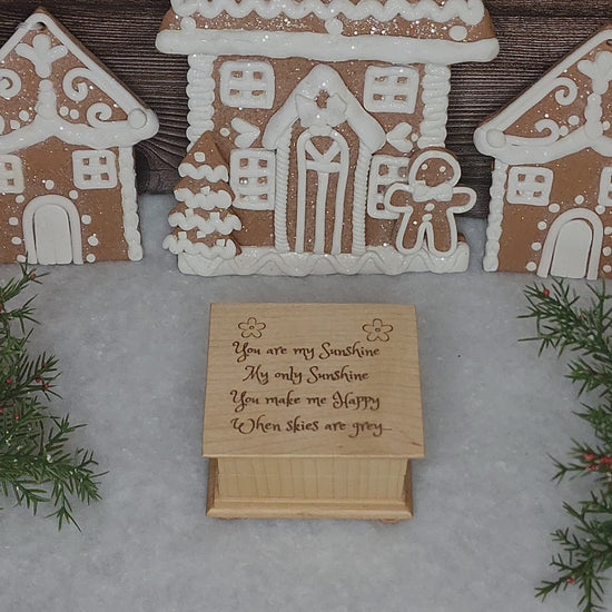 You are my sunshine music box in a gingerbread house and snow decorated setting