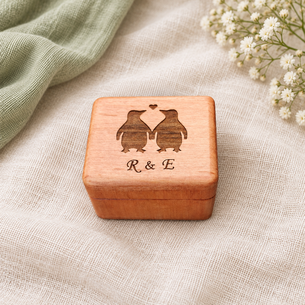 Penguin ring box on ivory linen