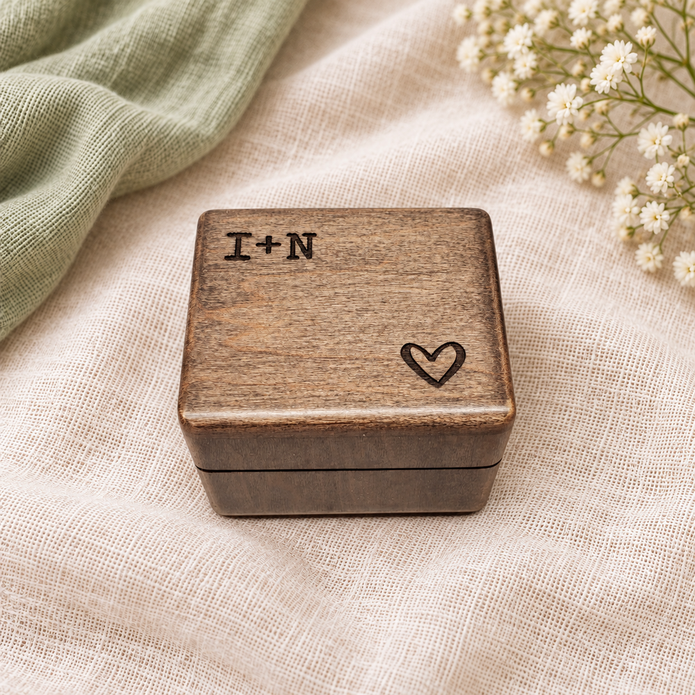 Engraved wooden ring box on ivory linen