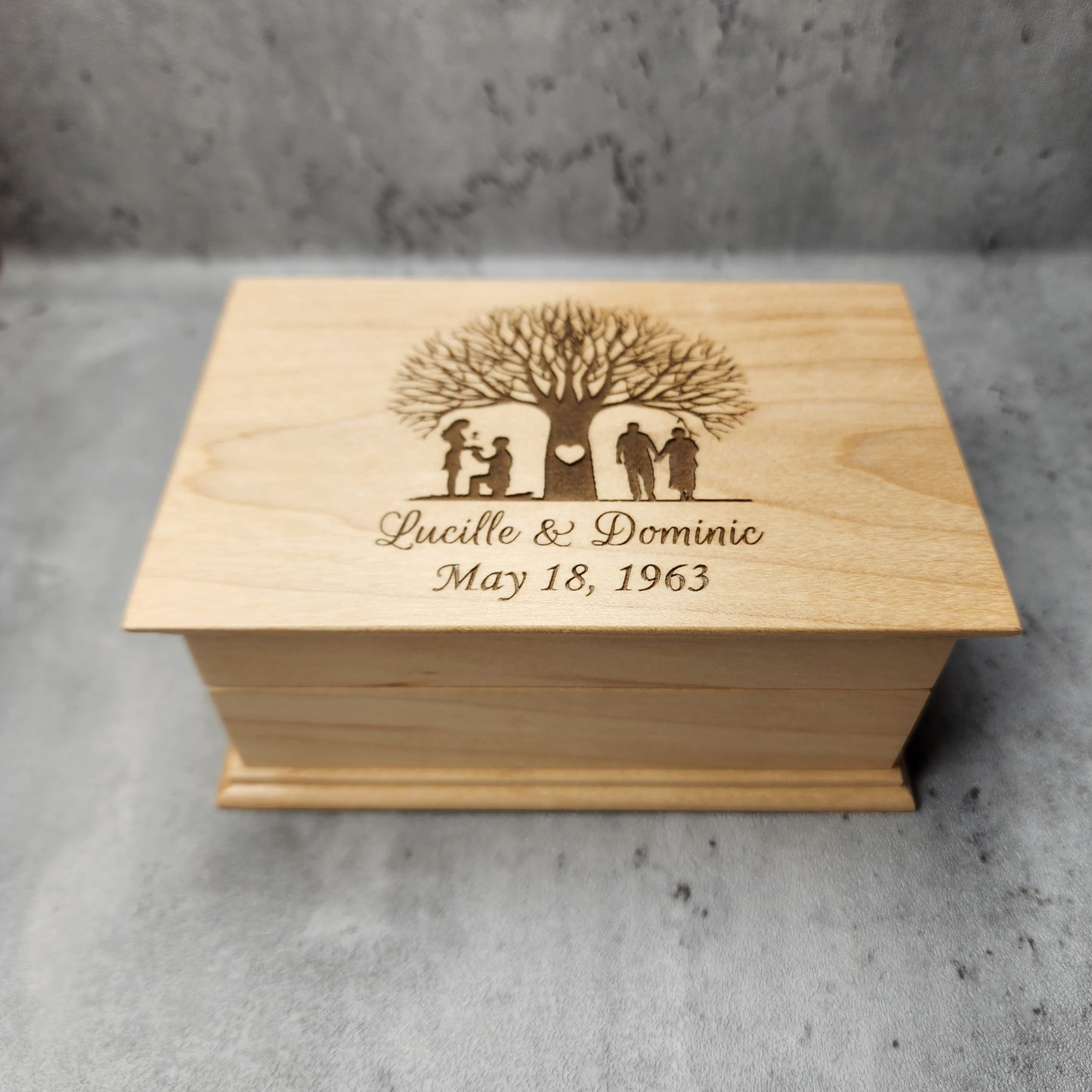 jewelry box in maple with a tree with a young couple on one side and an older couple on the other side of the tree, your names and date under the design