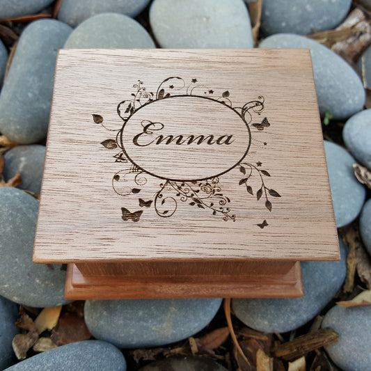name gift, wooden music box with name engraving on top along with an oval frame with vines and butterflies