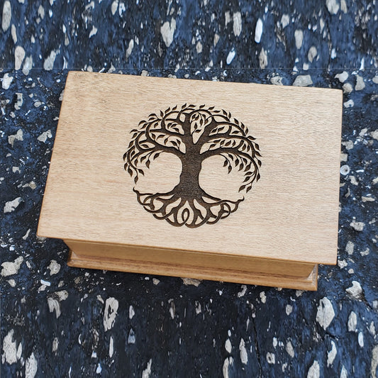 A wooden music jewelry box with a tree engraved on top, playing your song. Choose color