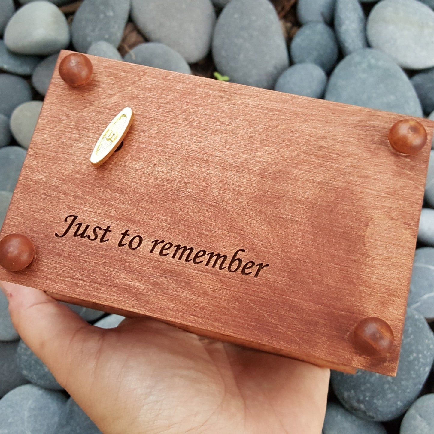 jewelry box with personalized engraving on the bottom side showing the wind up key, 4 cute button feet and the engraving says "Just to remember"