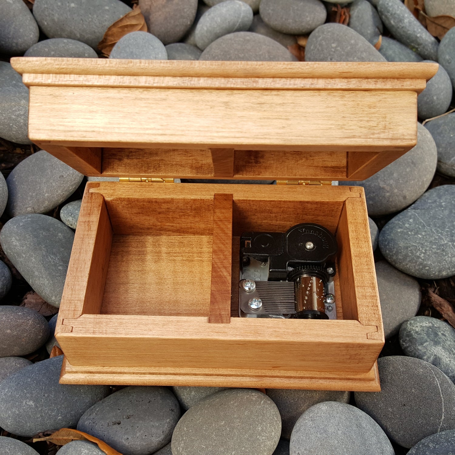 jewelry box with open lid showing music box movement built inside