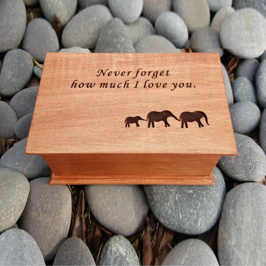 wooden jewelry box with musical movement built inside, Never forget how much I love you engraved on top along with an elephant family, choose color and song and personalized message to the back side of box
