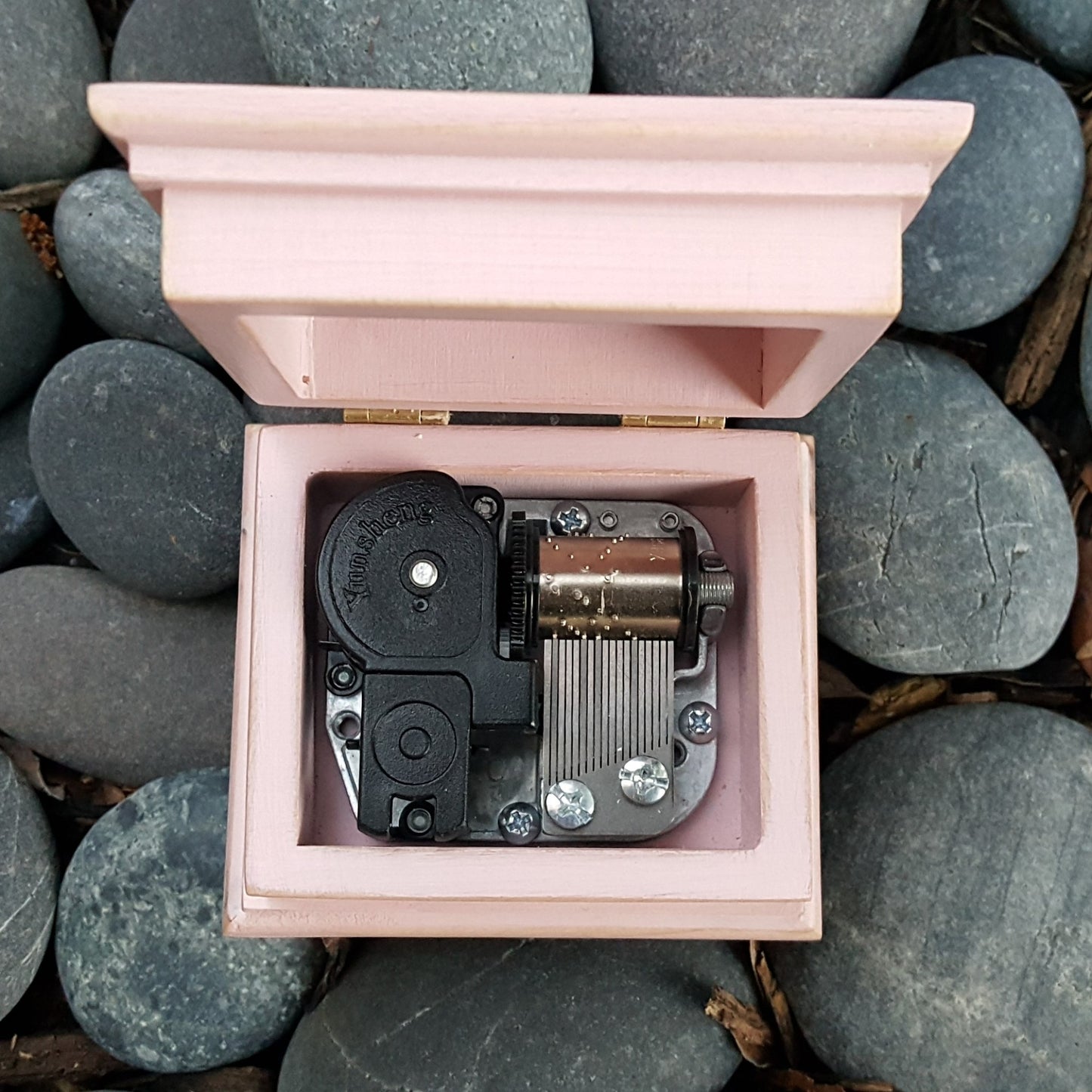 wooden music box in pink showing music box movement built inside, custom-made, choose color and song