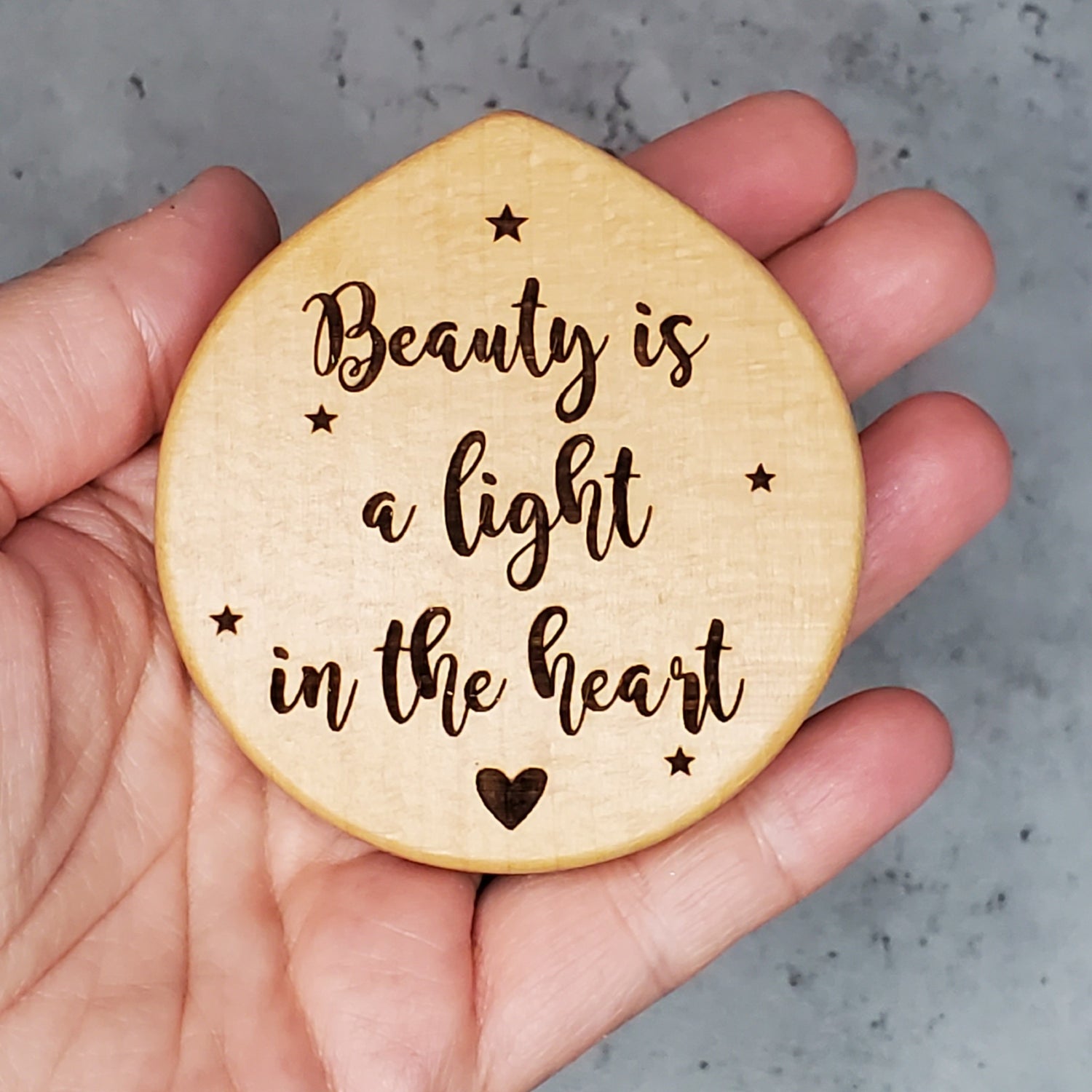 small compact mirror fits in your hands, suitable for little girls as well, with a beauty quote on the top