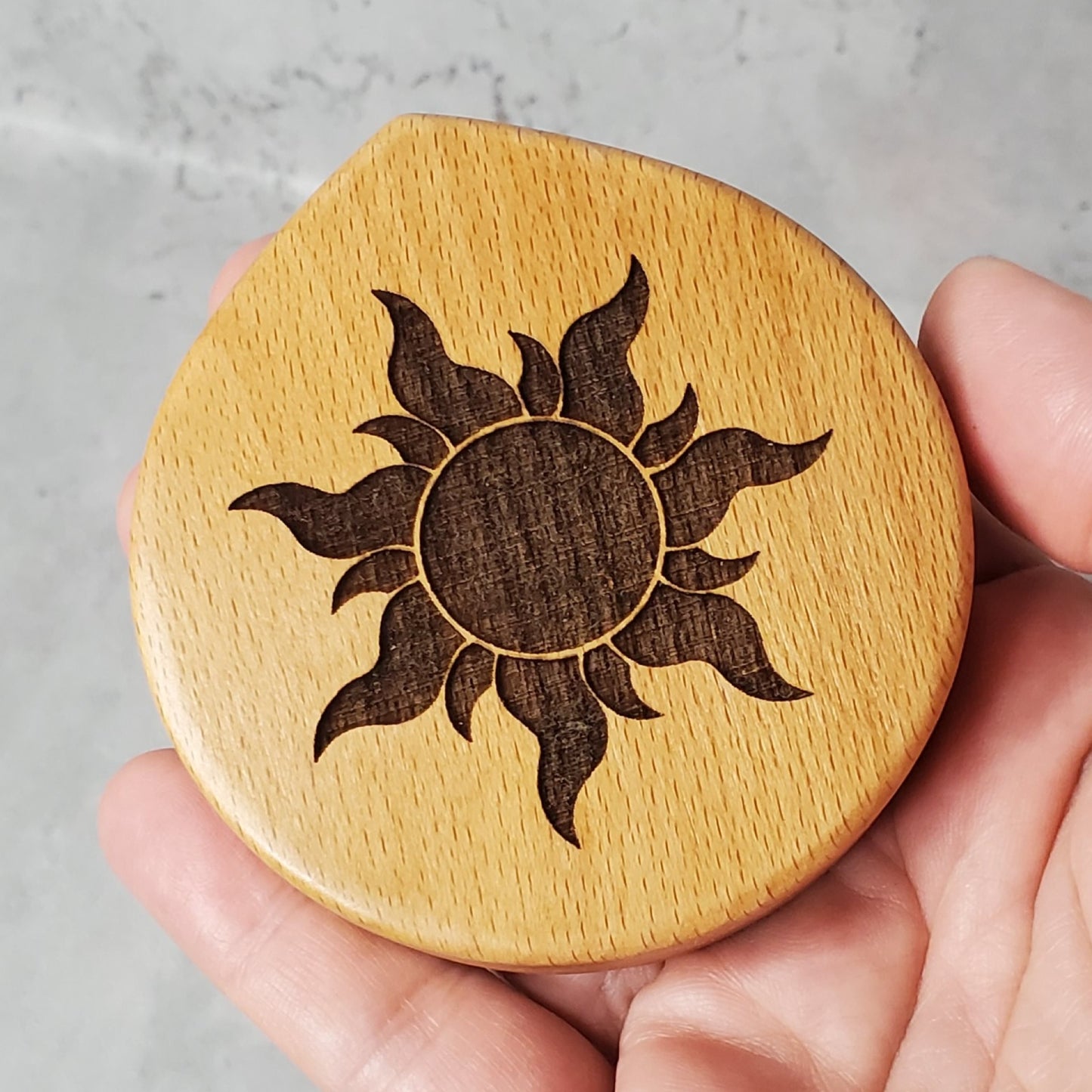 compact mirror with a sun engraved on the top, made out of maple wood and it fits into your hand, purse or pocket. Perfect gift for little girls as well